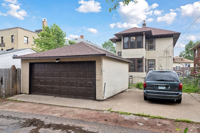 1601 Charles Ave, Saint Paul, MN 55104 - view of front of house with a detached garage, an outdoor structure, and roof with shingles