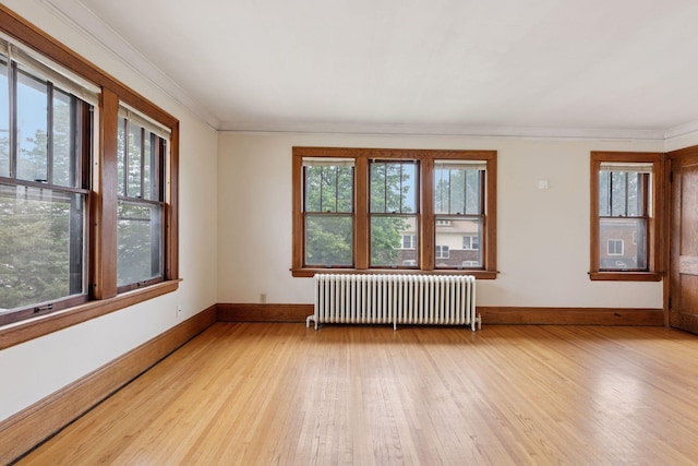 1601 Charles Ave, Saint Paul, MN 55104 - empty room featuring radiator heating unit, light wood finished floors, and crown molding