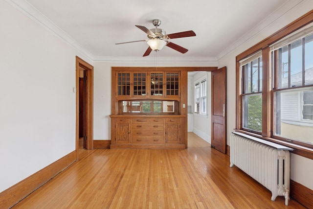 1601 Charles Ave, Saint Paul, MN 55104 - spare room with radiator, light wood-style flooring, ceiling fan, and crown molding
