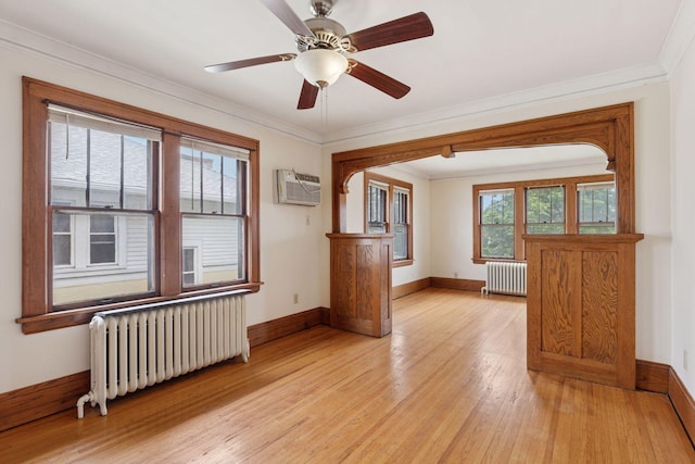 1601 Charles Ave, Saint Paul, MN 55104 - unfurnished room featuring radiator heating unit, a wall mounted AC, light wood-style flooring, crown molding, and a ceiling fan