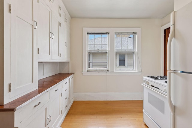 1601 Charles Ave, Saint Paul, MN 55104 - kitchen featuring white appliances, light wood-style floors, and white cabinetry