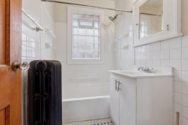 1601 Charles Ave, Saint Paul, MN 55104 - bathroom with radiator heating unit, vanity, shower / bath combination, and tile walls