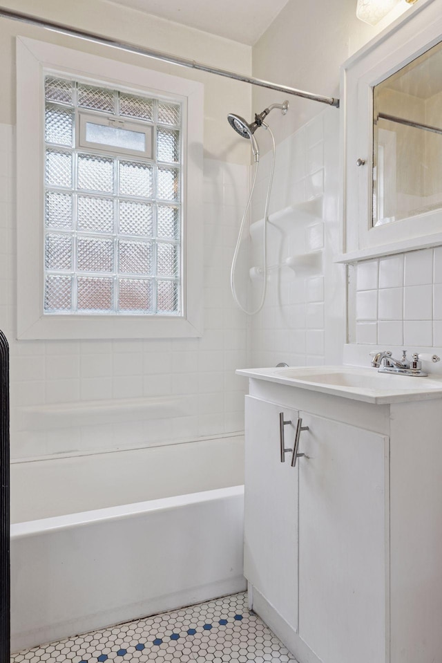 1601 Charles Ave, Saint Paul, MN 55104 - bathroom featuring vanity, shower / bath combination, tasteful backsplash, and tile patterned flooring