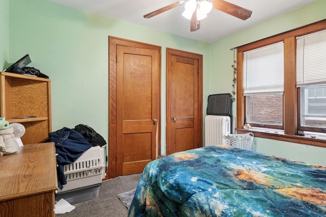 1601 Charles Ave, Saint Paul, MN 55104 - carpeted bedroom featuring radiator, multiple closets, and ceiling fan