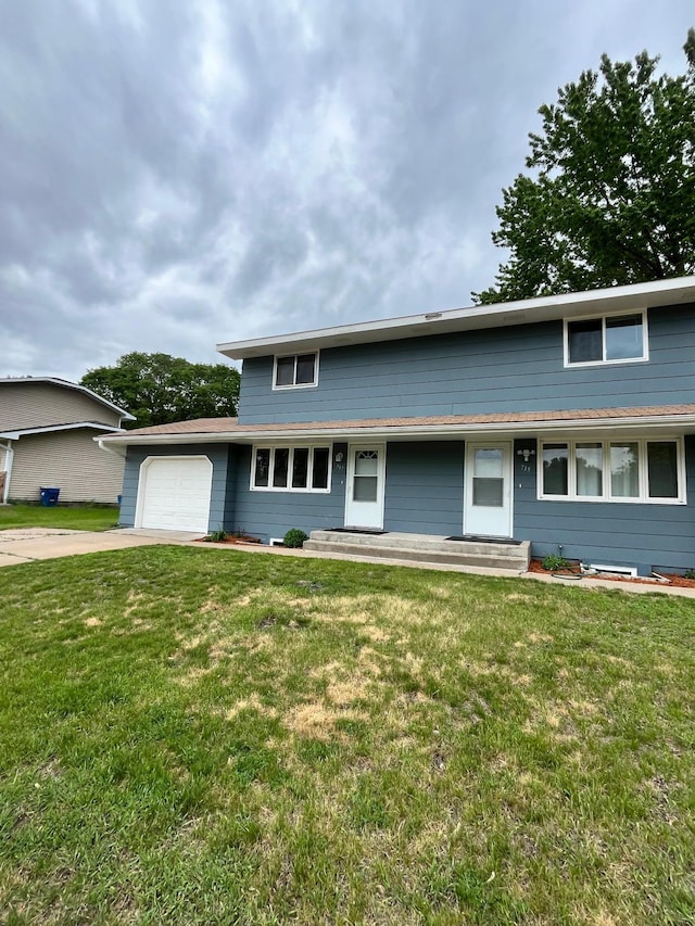 715 Circle Dr, Champlin, MN 55316 - view of front of home with an attached garage, driveway, and a front yard