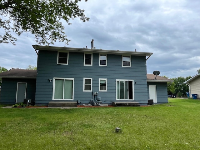715 Circle Dr, Champlin, MN 55316 - rear view of house featuring entry steps and a lawn