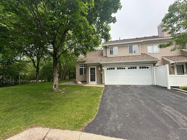 691 85th Ln NW Unit 1, Coon Rapids, MN 55433 - view of front facade with asphalt driveway, a front lawn, and a chimney