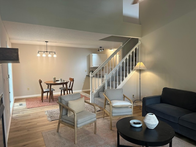 691 85th Ln NW Unit 1, Coon Rapids, MN 55433 - living area with light wood-style flooring, stairway, and baseboards