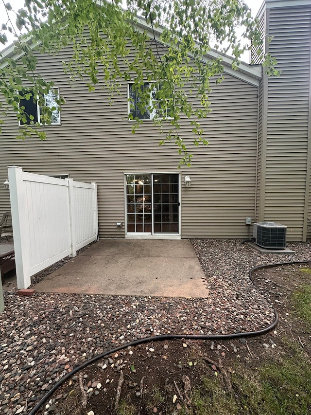 691 85th Ln NW Unit 1, Coon Rapids, MN 55433 - back of property featuring central AC unit and a patio area