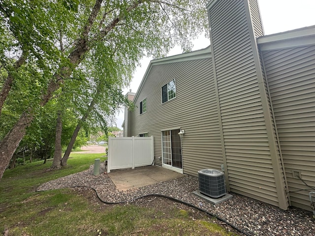691 85th Ln NW Unit 1, Coon Rapids, MN 55433 - back of property with central AC unit and a chimney