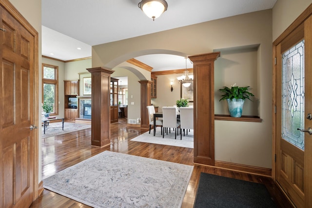 8867 Aviary Path, Inver Grove Heights, MN 55077 - entrance foyer featuring decorative columns, arched walkways, wood finished floors, baseboards, and crown molding