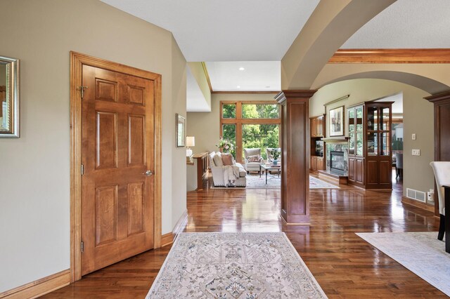 8867 Aviary Path, Inver Grove Heights, MN 55077 - foyer entrance featuring dark wood finished floors, a glass covered fireplace, baseboards, and recessed lighting