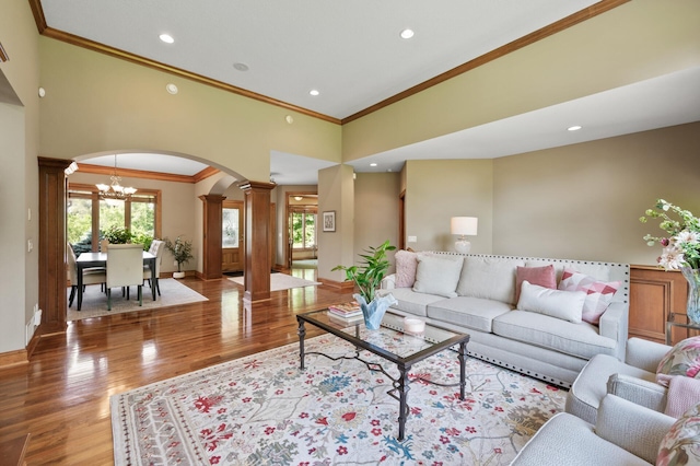 8867 Aviary Path, Inver Grove Heights, MN 55077 - living room featuring ornate columns, arched walkways, crown molding, light wood-style flooring, and recessed lighting
