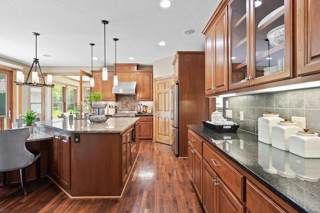 8867 Aviary Path, Inver Grove Heights, MN 55077 - kitchen featuring wall chimney range hood, freestanding refrigerator, dark wood-style flooring, decorative backsplash, and recessed lighting