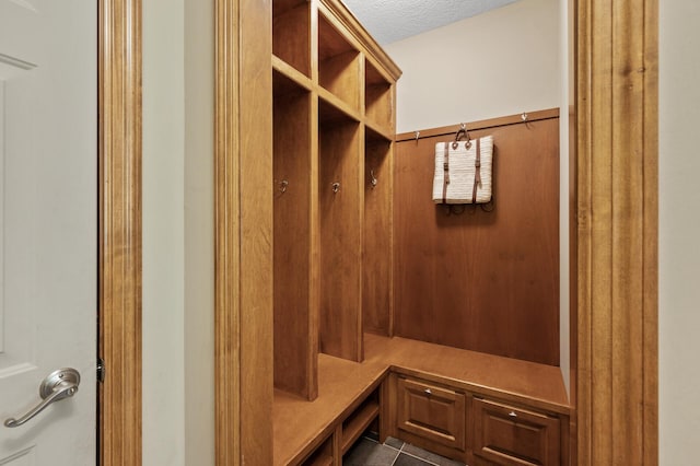 8867 Aviary Path, Inver Grove Heights, MN 55077 - mudroom featuring a textured ceiling and dark tile patterned flooring