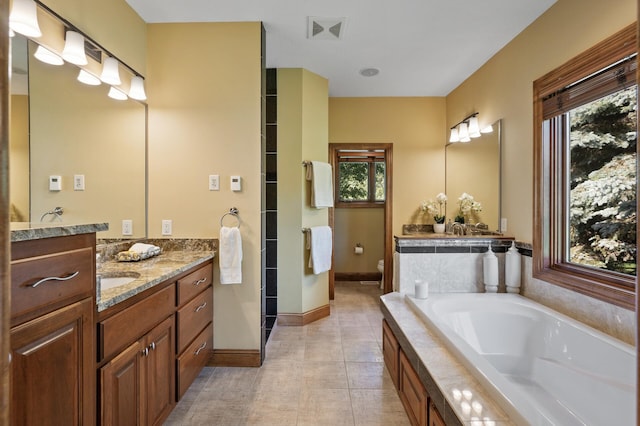 8867 Aviary Path, Inver Grove Heights, MN 55077 - full bathroom featuring a garden tub, toilet, vanity, baseboards, and a shower