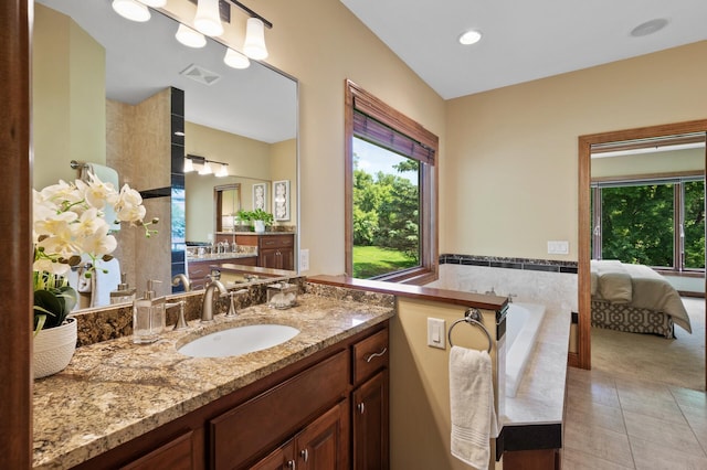 8867 Aviary Path, Inver Grove Heights, MN 55077 - bathroom featuring plenty of natural light, vanity, tile patterned floors, tiled bath, and recessed lighting