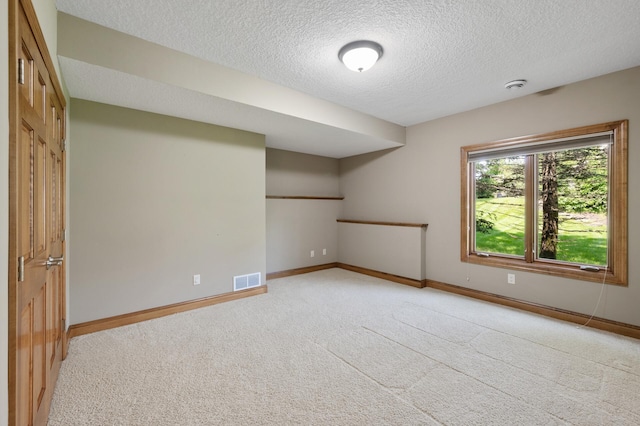 8867 Aviary Path, Inver Grove Heights, MN 55077 - spare room with a textured ceiling, light colored carpet, baseboards, and a smoke detector