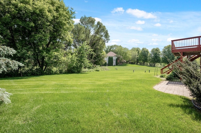 8867 Aviary Path, Inver Grove Heights, MN 55077 - view of green lawn featuring a deck, stairs, and view of scattered trees