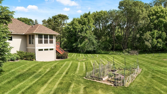 8867 Aviary Path, Inver Grove Heights, MN 55077 - view of grassy yard with a vegetable garden and stairway