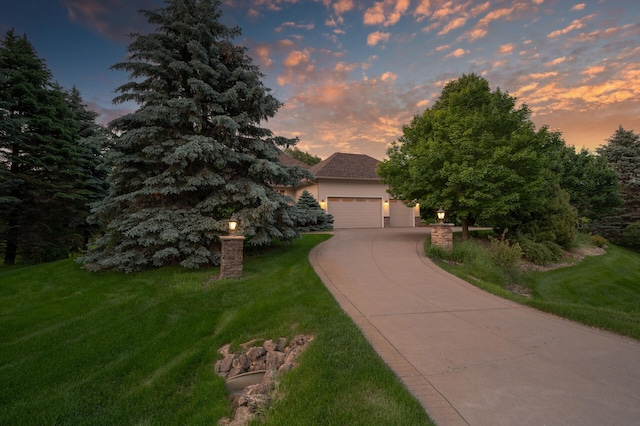 8867 Aviary Path, Inver Grove Heights, MN 55077 - obstructed view of property with concrete driveway, an attached garage, a front yard, and stucco siding