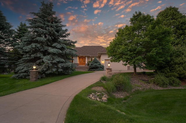 8867 Aviary Path, Inver Grove Heights, MN 55077 - obstructed view of property featuring driveway, stucco siding, a yard, and an attached garage