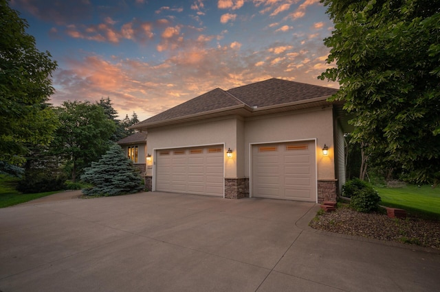 8867 Aviary Path, Inver Grove Heights, MN 55077 - view of front of home with driveway, stucco siding, a garage, and stone siding