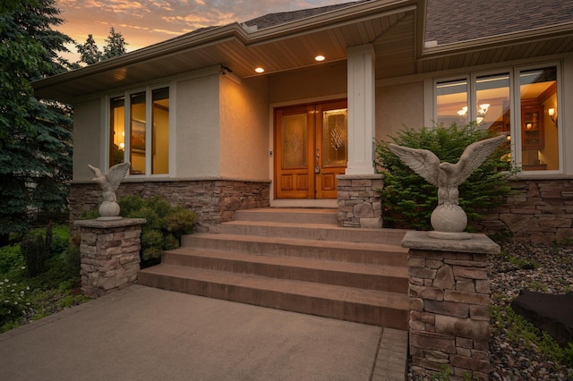 8867 Aviary Path, Inver Grove Heights, MN 55077 - property entrance featuring stucco siding, stone siding, and a shingled roof