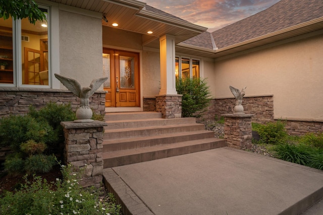 8867 Aviary Path, Inver Grove Heights, MN 55077 - entrance to property with stucco siding, stone siding, and roof with shingles