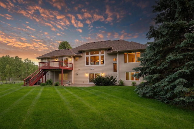8867 Aviary Path, Inver Grove Heights, MN 55077 - back of house at dusk with stairway, a yard, a wooden deck, and a patio