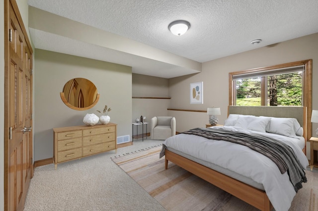 8867 Aviary Path, Inver Grove Heights, MN 55077 - bedroom featuring a textured ceiling, light colored carpet, and baseboards