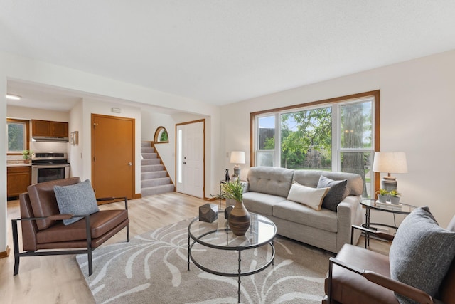 2524 Bryant Ave N, Minneapolis, MN 55411 - living area with stairs, healthy amount of natural light, and light wood-type flooring