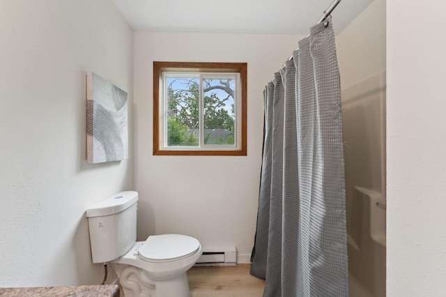2524 Bryant Ave N, Minneapolis, MN 55411 - full bath featuring a baseboard radiator, toilet, wood finished floors, curtained shower, and baseboards
