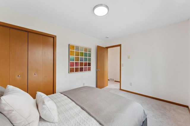 2524 Bryant Ave N, Minneapolis, MN 55411 - bedroom with a closet, light carpet, and baseboards