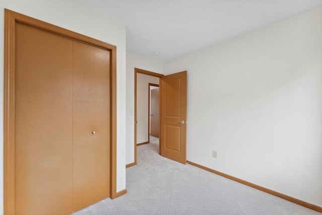 2524 Bryant Ave N, Minneapolis, MN 55411 - unfurnished bedroom featuring light carpet, a closet, and baseboards