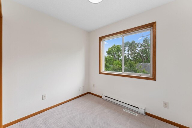 2524 Bryant Ave N, Minneapolis, MN 55411 - unfurnished room with a baseboard heating unit, baseboards, and carpet flooring