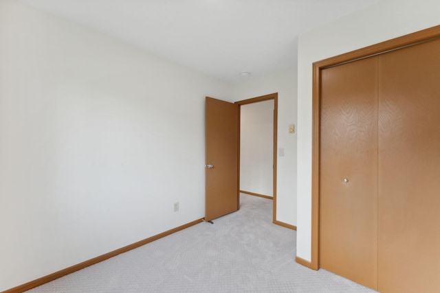 2524 Bryant Ave N, Minneapolis, MN 55411 - unfurnished bedroom featuring light colored carpet, a closet, and baseboards