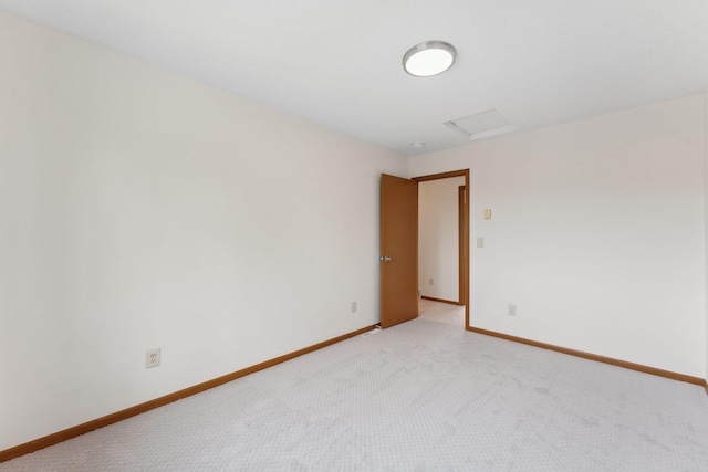 2524 Bryant Ave N, Minneapolis, MN 55411 - empty room featuring attic access, light colored carpet, and baseboards