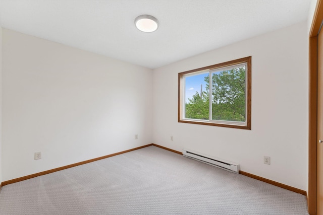 2524 Bryant Ave N, Minneapolis, MN 55411 - empty room featuring a baseboard heating unit, light colored carpet, and baseboards