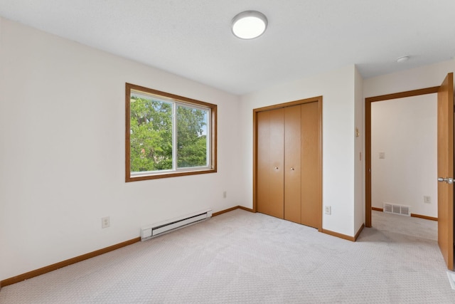 2524 Bryant Ave N, Minneapolis, MN 55411 - unfurnished bedroom with a baseboard radiator, carpet flooring, a closet, and baseboards