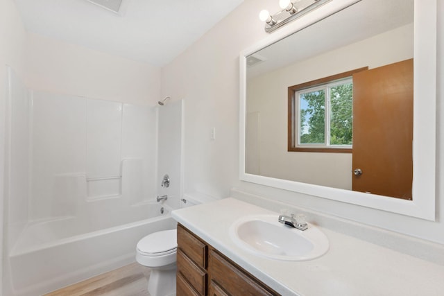 2524 Bryant Ave N, Minneapolis, MN 55411 - bathroom featuring toilet, vanity, shower / bathtub combination, and wood finished floors