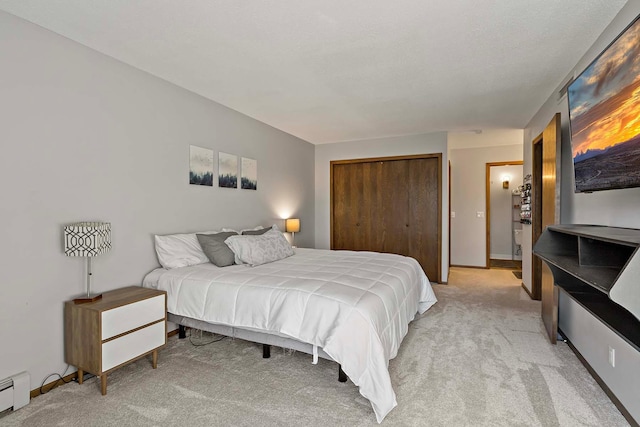 9700 Portland Ave S Unit 334, Bloomington, MN 55420 - bedroom with light carpet, a closet, and a baseboard heating unit