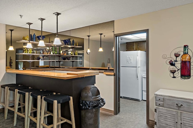 9700 Portland Ave S Unit 334, Bloomington, MN 55420 - indoor bar with white appliances, hanging light fixtures, and a textured ceiling