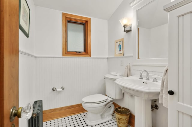 2022 Summit Ave, Saint Paul, MN 55105 - half bath with radiator heating unit, wainscoting, toilet, a sink, and tile patterned flooring