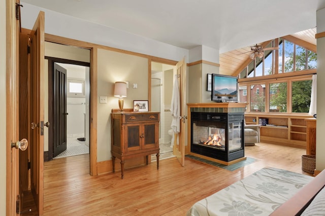 2022 Summit Ave, Saint Paul, MN 55105 - living area with a multi sided fireplace, wood finished floors, a ceiling fan, and vaulted ceiling