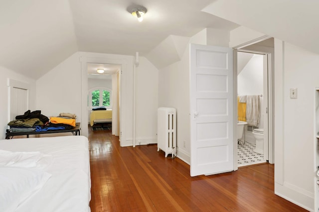 2022 Summit Ave, Saint Paul, MN 55105 - bedroom featuring radiator, hardwood / wood-style floors, ensuite bathroom, vaulted ceiling, and baseboards