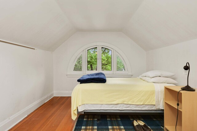 2022 Summit Ave, Saint Paul, MN 55105 - bedroom with wood finished floors, vaulted ceiling, and baseboards
