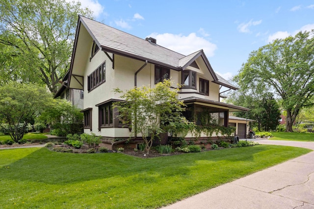 2022 Summit Ave, Saint Paul, MN 55105 - view of property exterior with stucco siding, driveway, and a yard