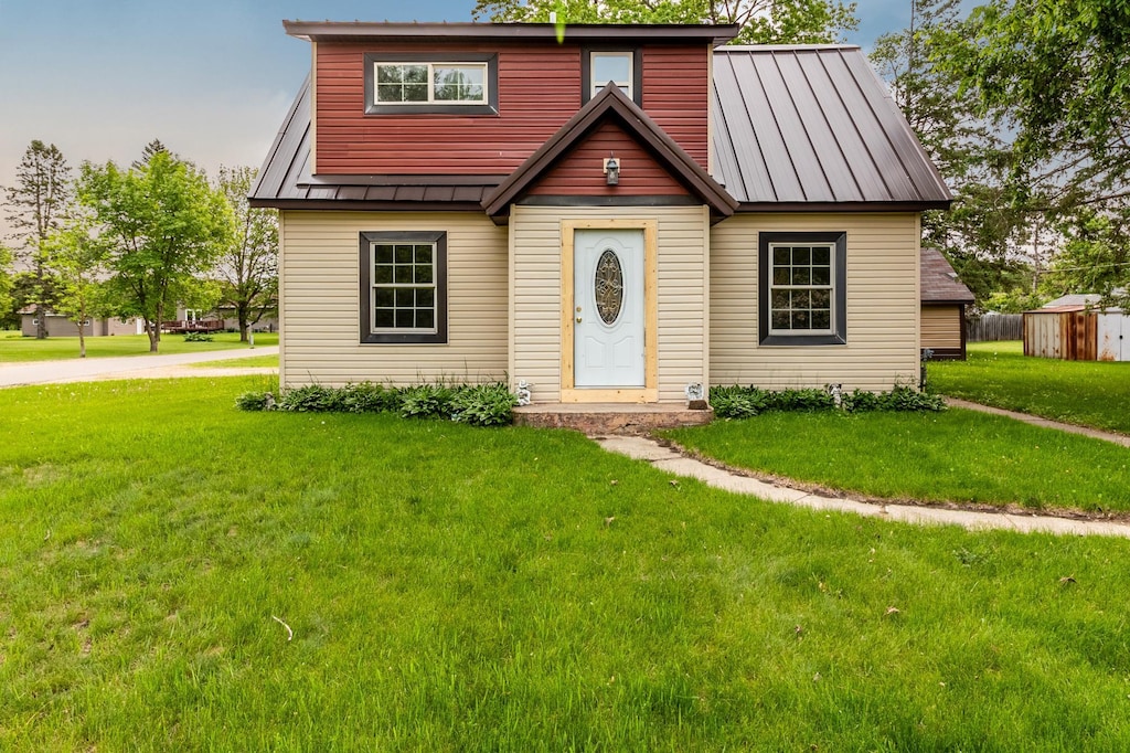 407 John St N, Clarissa, MN 56440 - view of front of home with a standing seam roof, a front yard, and metal roof