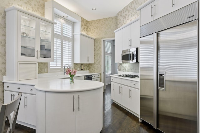 3490 Fairway Ln, Minnetonka, MN 55305 - kitchen with appliances with stainless steel finishes, wallpapered walls, dark wood-style flooring, a peninsula, and a sink